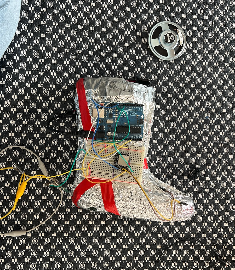 The crazy shoe assembly: Arduino, breadboard, and wires strapped to a foil-wrapped rubber boot