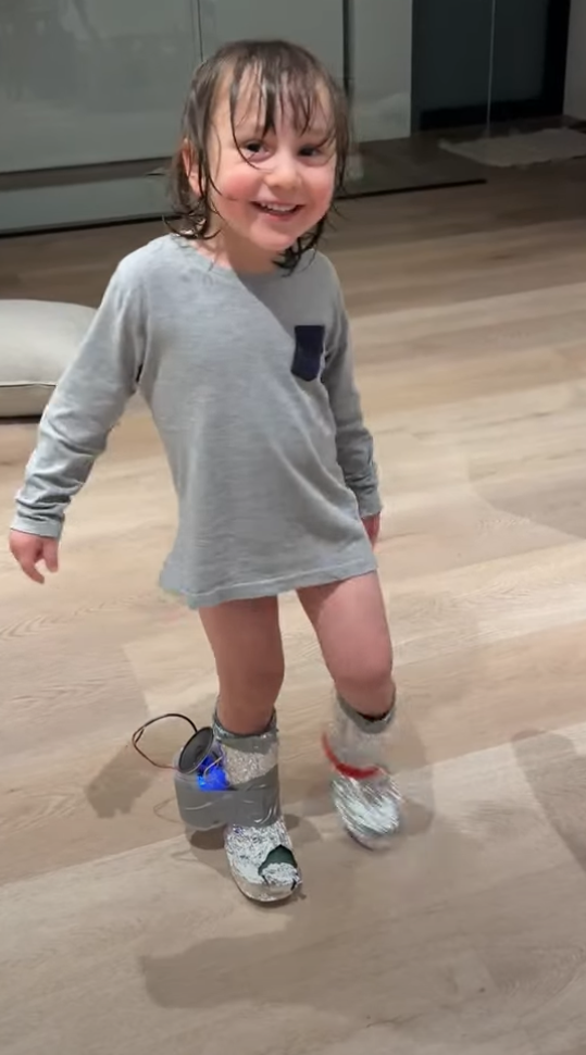 Vicente wearing the crazy shoe, grinning